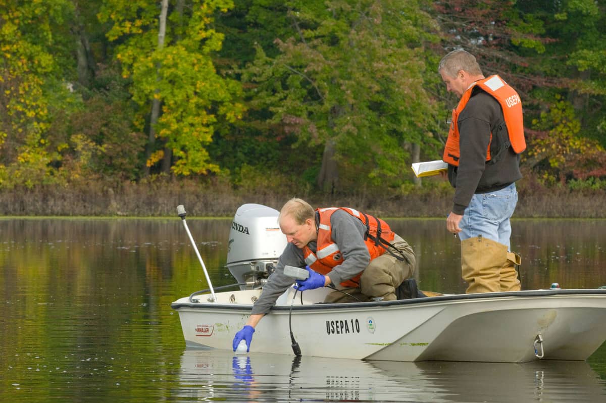 Scientists collecting a water sample for quality analysis